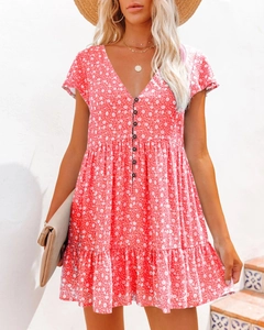 Detail of red floral V-neck dress with buttons and tiered ruffle hem for summer leisure