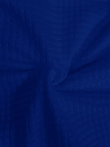 Detailed macro shot of royal blue quilted knit fabric with square textured pattern