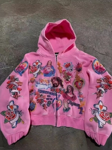 Detail of pink hoodie with religious art prints featuring Jesus portrait and roses