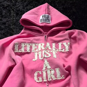 Pink Y2K zip-up hoodie featuring white distressed patches and Literally Just A Girl text