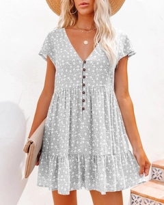 Detail of V-neckline floral dress with button decor and soft ruffled sleeves for summer