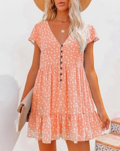 Detail of V-neckline and button front on floral summer mini dress with ruffles
