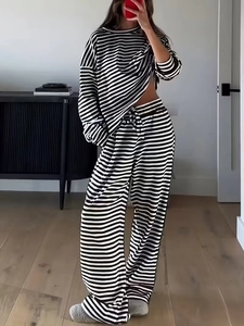 Detail of black and white striped long sleeve top and drawstring wide-leg pants set