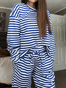 Detail of blue and white striped lounge set featuring drawstring waist and soft knit texture