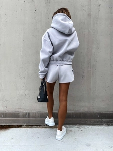 Detail of light grey knit hoodie set featuring drawstring hem and matching sport shorts
