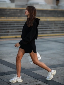 Detail of black long-sleeved hoodie and side-slit shorts in high-quality cotton blend