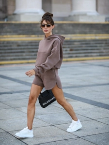 Detail showing curved side slit on high-waisted shorts and heavy knit cotton texture