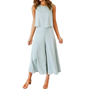 Detail of light green summer two-piece set featuring cotton linen texture and wide leg pants
