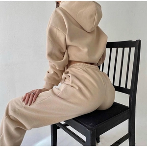 Detailed side view of beige fleece two-piece lounge set with hoodie and high-waist joggers