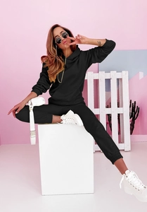 Detailaufnahme von schwarzem Kapuzenpullover und passender Jogginghose für Damen