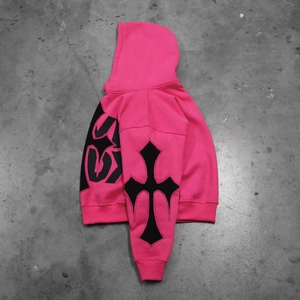 Detail of gothic cross print on bright pink heavy cotton hoodie with ribbed cuffs