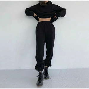 Detailed view of women's black cropped hoodie and high waist joggers tracksuit