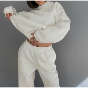 Detail view of cream-white loungewear set featuring hoodie with kangaroo pocket and joggers