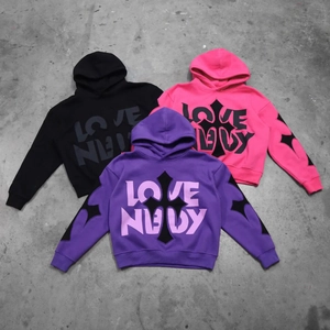 Detail of cross prints and LOVE NUDE lettering on heavy cotton oversized hoodies