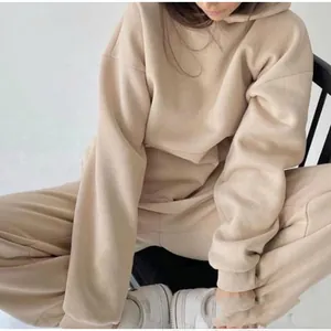 Detail of oversized apricot hoodie and matching joggers with elastic cuffs and pocket