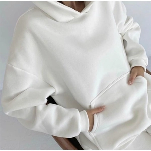 Detail of white oversized hoodie showing soft fleece texture and kangaroo pocket
