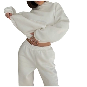 Women's white oversized tracksuit featuring a casual drawstring hoodie and joggers set