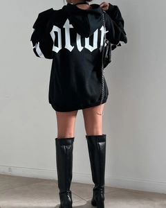 Back view of oversized black hoodie featuring white Gothic lettering and chain bag