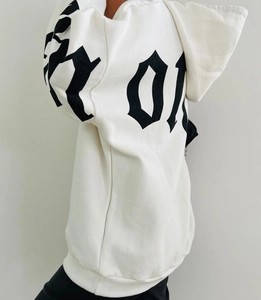 Detail of white oversized hoodie featuring black gothic graphic print on the back