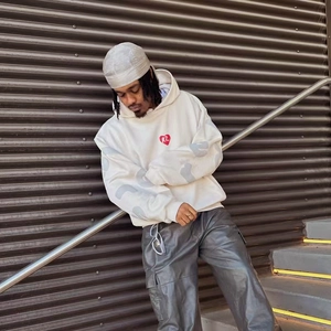 Detail of white hoodie featuring red heart foam print and grey sleeve lettering design