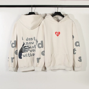 Detail of red heart foam print and sleeve lettering on cream oversized hoodie