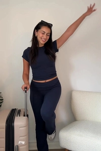 Navy blue two-piece knit set featuring a cropped short sleeve top and high-waisted pants