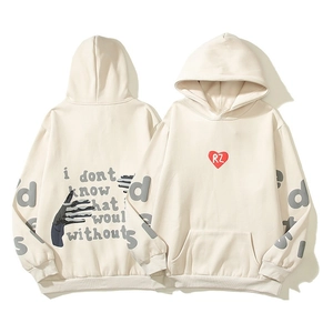 Macro shot of foam puff print heart logo and artistic text on a cream hoodie