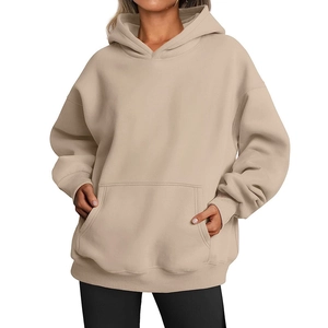 Detailed view of beige oversized hoodie featuring kangaroo pocket and ribbed cuffs finish