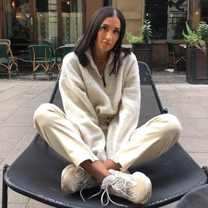 Detail of off-white sherpa half-zip pullover featuring drop shoulder and plush texture