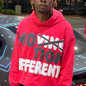 Close-up of red street-style hoodie with bold black and white graffiti letter printing