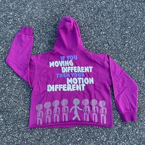 Close-up of pink hoodie with foam printed puff lettering and rhinestone hem details