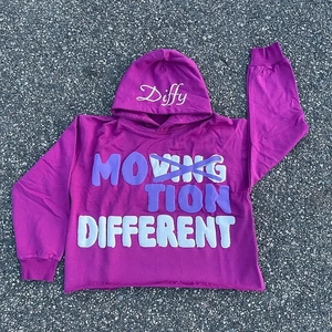 Detail of purple cropped hoodie with 3D foam puff print lettering and raw edge hem style