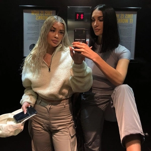 Mirror selfie showing a woman wearing a beige sherpa zip-up sweatshirt and cargo pants