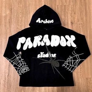 Close-up of black hoodie featuring white foam print text and intricate spider web graphics