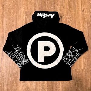 Detail of gothic hoodie featuring spider web sleeve prints and Archive hood graphics