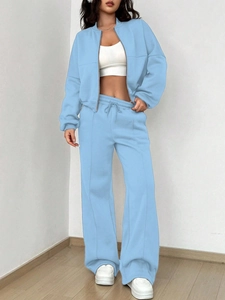 Detail of light blue two-piece tracksuit with zip-up jacket and drawstring wide-leg pants