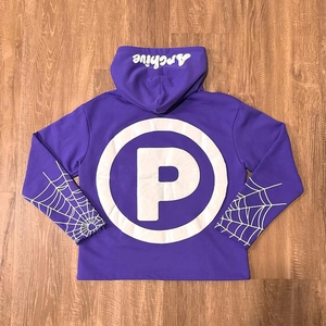 Detail view of purple hoodie with spider web sleeve print and white foam letter graphics