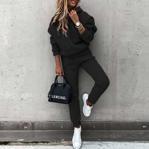 Detail of soft knit fabric texture on a black long sleeve hoodie and jogger set