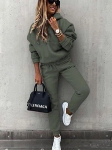 Detail of olive green two-piece tracksuit featuring a hoodie and high-waist joggers