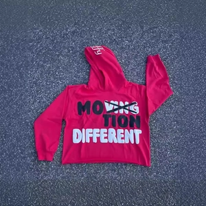 Streetwear bright red hoodie featuring bold graffiti letters on a flat asphalt background