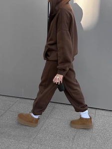 Straßenansicht eines braunen Oversized Kapuzenpullovers und Jogginghose im passenden Set