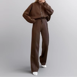 Detail of coffee brown track set featuring high-waisted wide leg pants with seam stitch