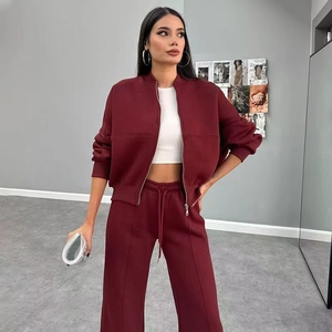 Close-up of burgundy high-waist drawstring wide-leg pants and cropped zip-up jacket set