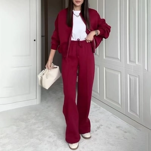 Close-up of wine red tracksuit details with zipper jacket and high-waisted pants