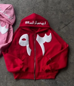 Close-up of pink Y2K zip-up hoodie featuring white applique embroidery and metal zipper