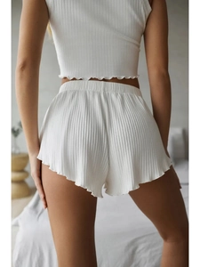 Women's white ribbed sleeveless top and ruffled shorts two-piece loungewear set
