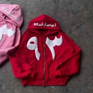 Y2K hip-hop zip-up hoodies in red and pink with white embroidery on a stone ground