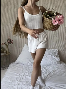 White ribbed loungewear set with hollow-out lace camisole and wavy hem shorts for women
