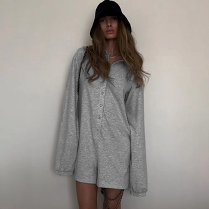 Relaxed fit light grey long sleeve knit romper with button front and casual drop shoulders