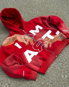 Detail of red Y2K hoodie with white I AM ART embroidery and artistic hand print